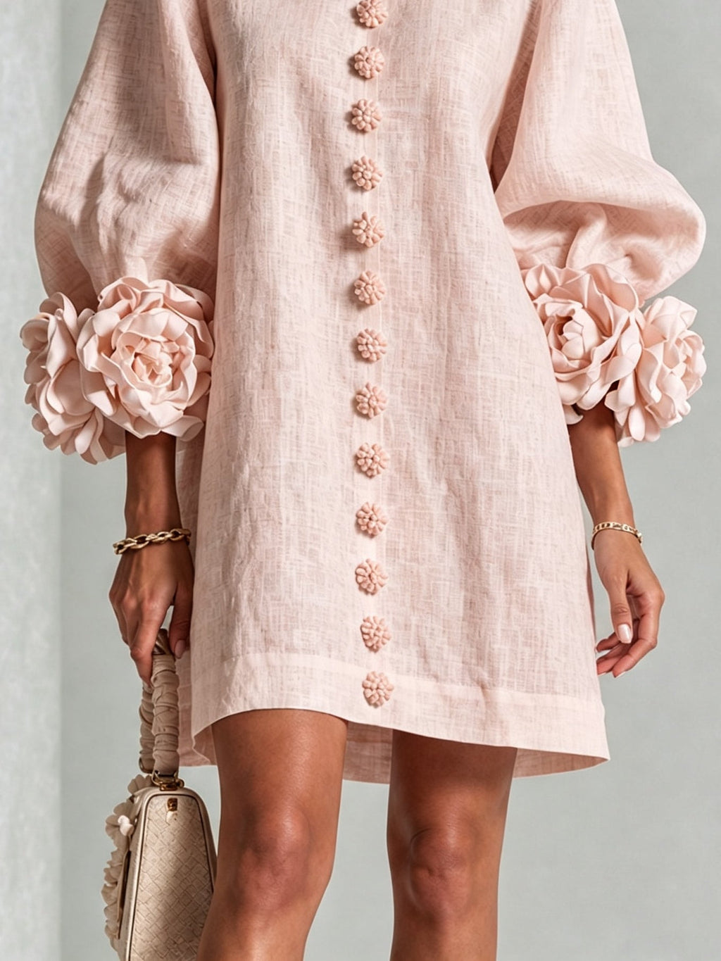 Pink mini dress with long sleeves, flower buttons and large floral cuffs