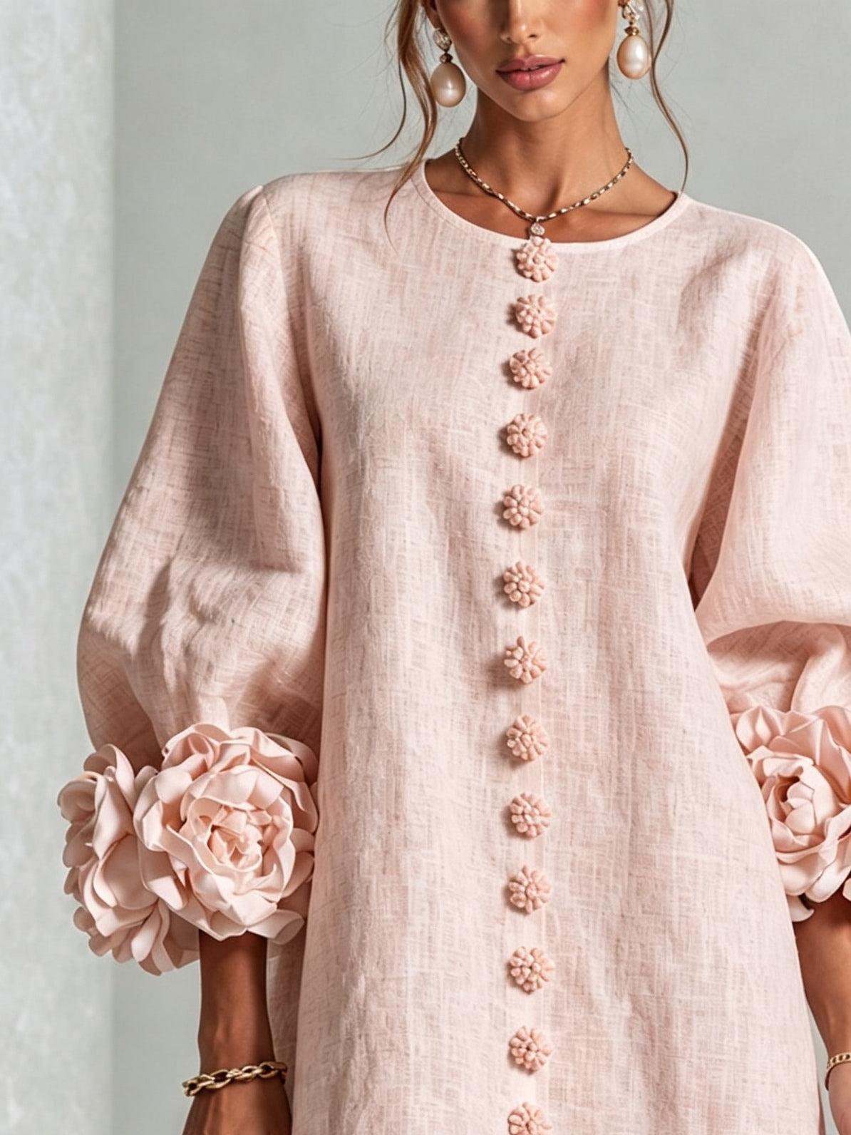 Pink mini dress with long sleeves, flower buttons and large floral cuffs
