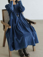Women's long-sleeve velvety midi dress with a round neckline and full gathered skirt
