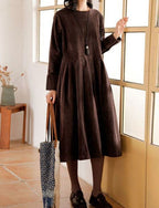 Women's long-sleeve velvety midi dress with a round neckline and full gathered skirt