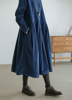 Women's long-sleeve velvety midi dress with a round neckline and full gathered skirt