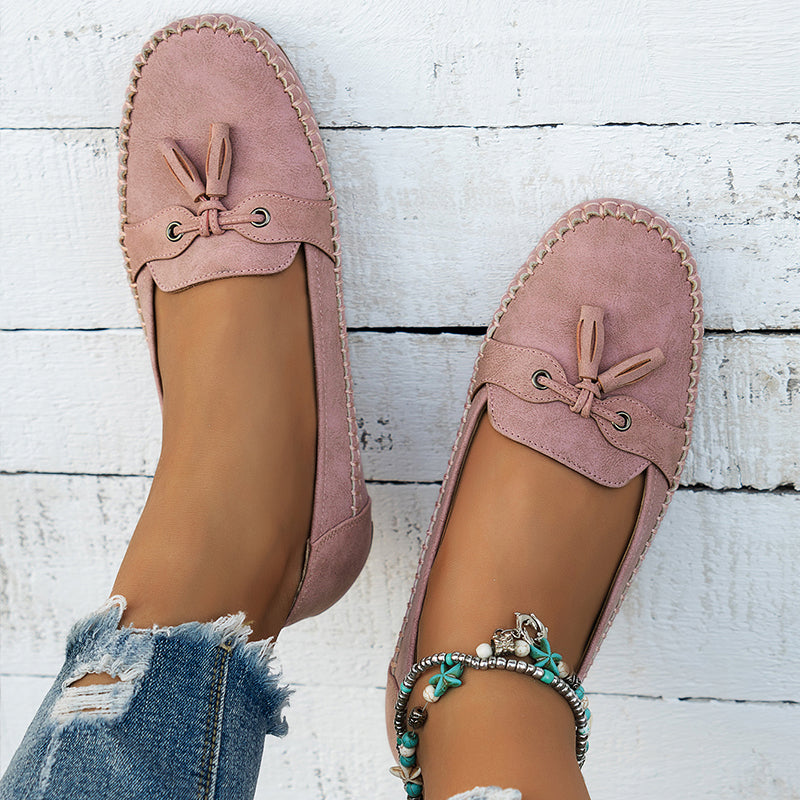 Women's flat moccasin loafers with decorative lacing and rounded toes