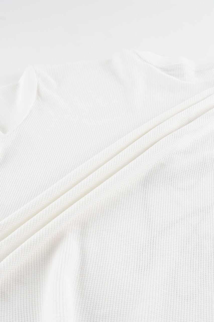 White waffle sweatshirt with black script graphic and long sleeves