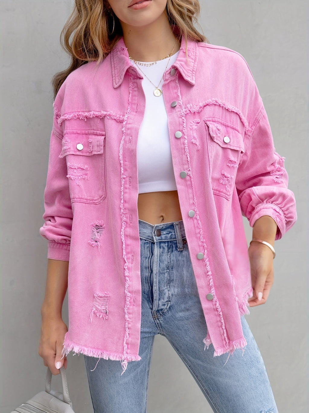 Women's pink distressed denim jacket with pockets and frayed hem