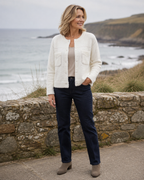 Women's white textured knit jacket with crew neck, buttons and two front pockets