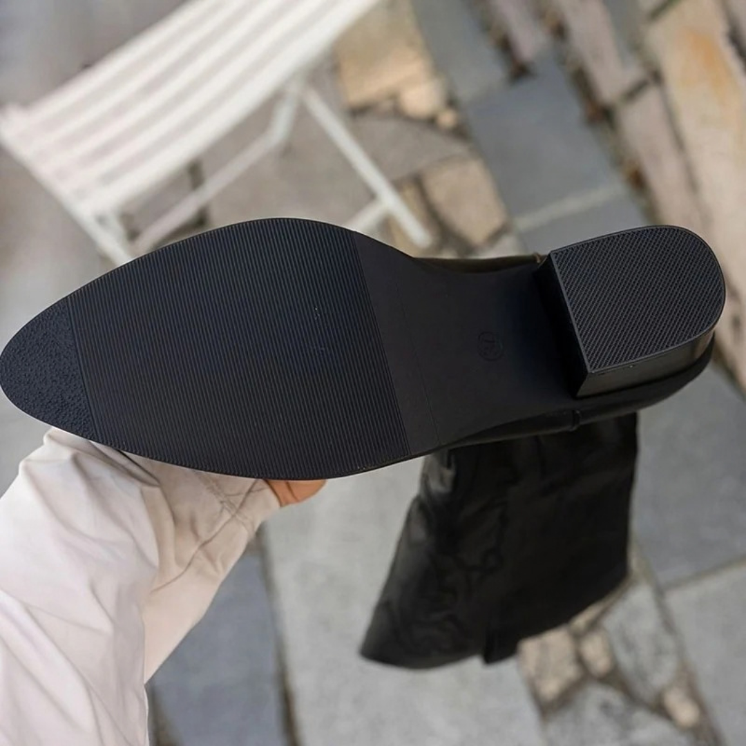 Black women's knee-high western boots with stitched panels and block heels