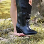 Black women's knee-high western boots with stitched panels and block heels