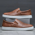 Men's slip-on loafers with rounded toes and contrasting white soles