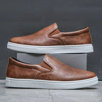 Men's slip-on loafers with rounded toes and contrasting white soles