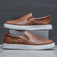 Men's slip-on loafers with rounded toes and contrasting white soles
