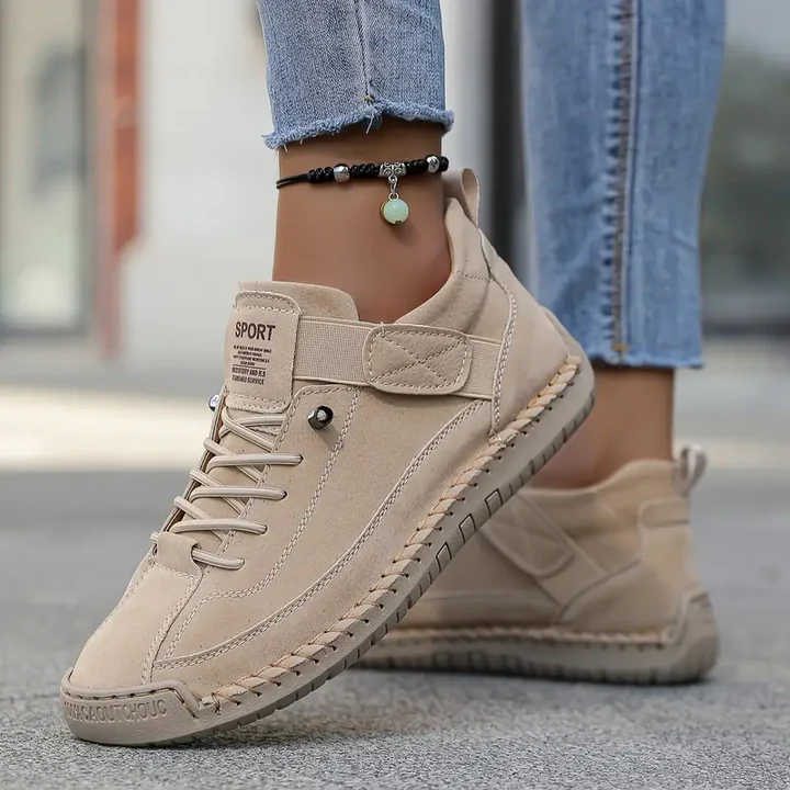 High-top sneakers with lace-up front and stitched panels