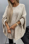 Women's loose knit poncho sweater with crew neckline and wide sleeves