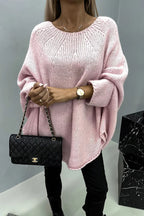 Women's loose knit poncho sweater with crew neckline and wide sleeves