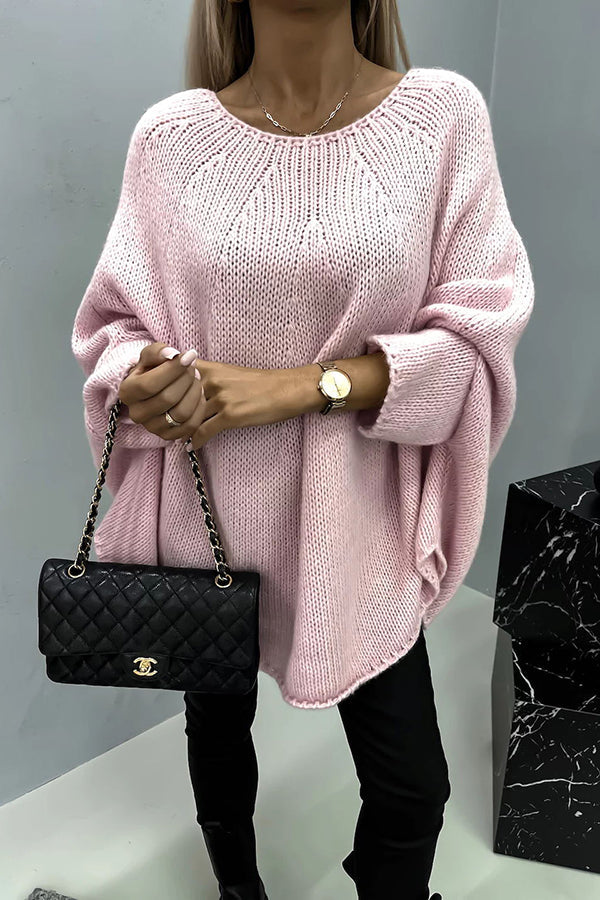 Women's loose knit poncho sweater with crew neckline and wide sleeves