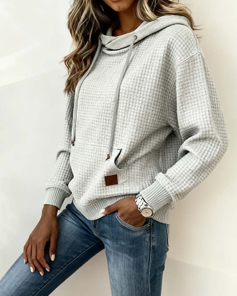 Women's grey waffle-textured hooded sweatshirt with drawstrings and front kangaroo pocket