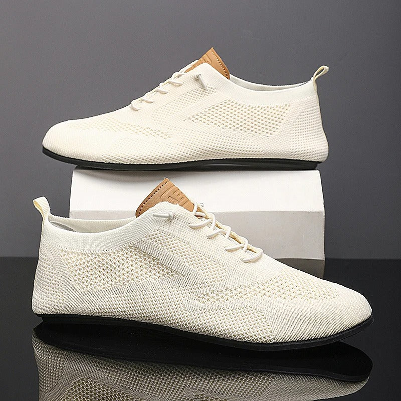 Knit sneakers with lace-up fronts, round toes and pull tabs