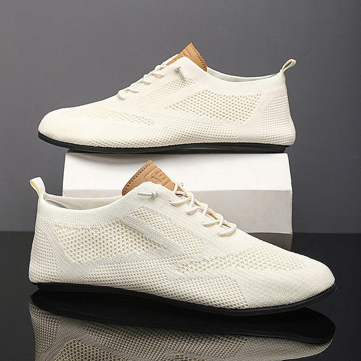 Knit sneakers with lace-up fronts, round toes and pull tabs