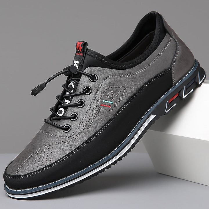Men's lace-up Oxford-style shoes with contrasting panels and flat patterned soles