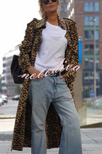 Woman wearing a leopard print long sleeve midi trench coat