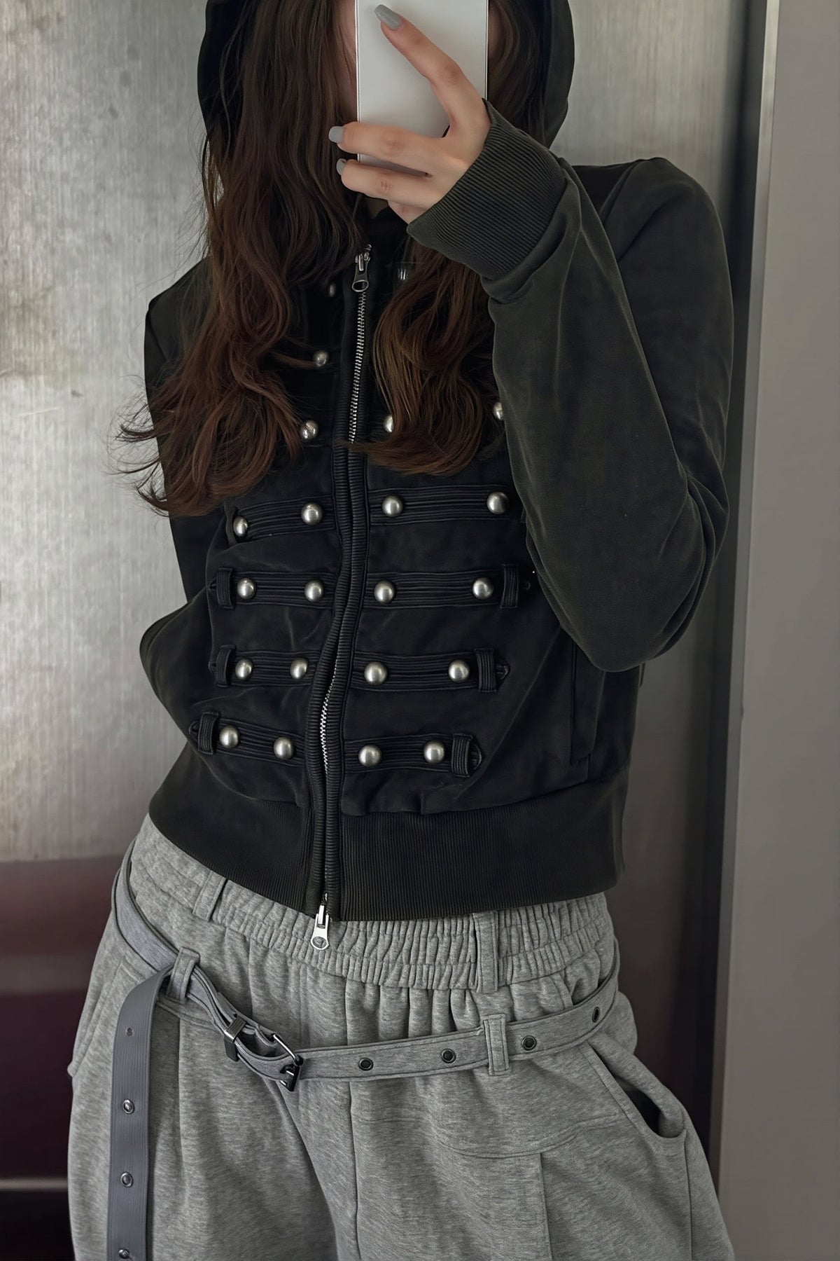 Women's black fitted hoodie with studded front trims and zip fastening