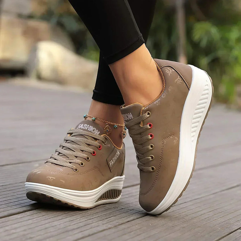 Women's low-top lace-up sneaker with printed symbols, round toe and white sole