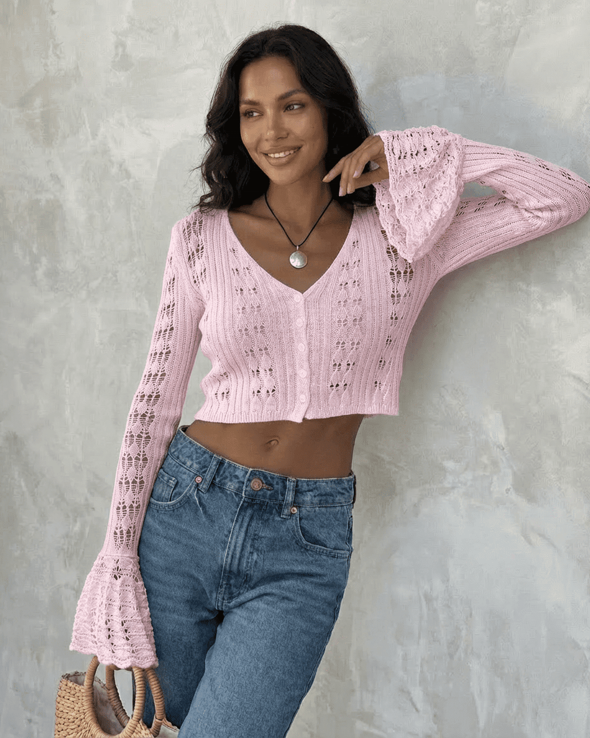 Women's pink cropped openwork cardigan with V-neckline and flared cuffs