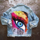 Women's denim jacket with colourful graphic eye print on the back
