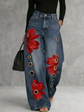 Women's high-waisted wide-leg jeans with red floral embroidery and gold eyelets