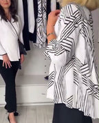 Women's black geometric pleated blouse with V-neckline and long sleeves