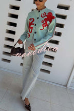 Women's pale blue cardigan with red octopus graphics and button front