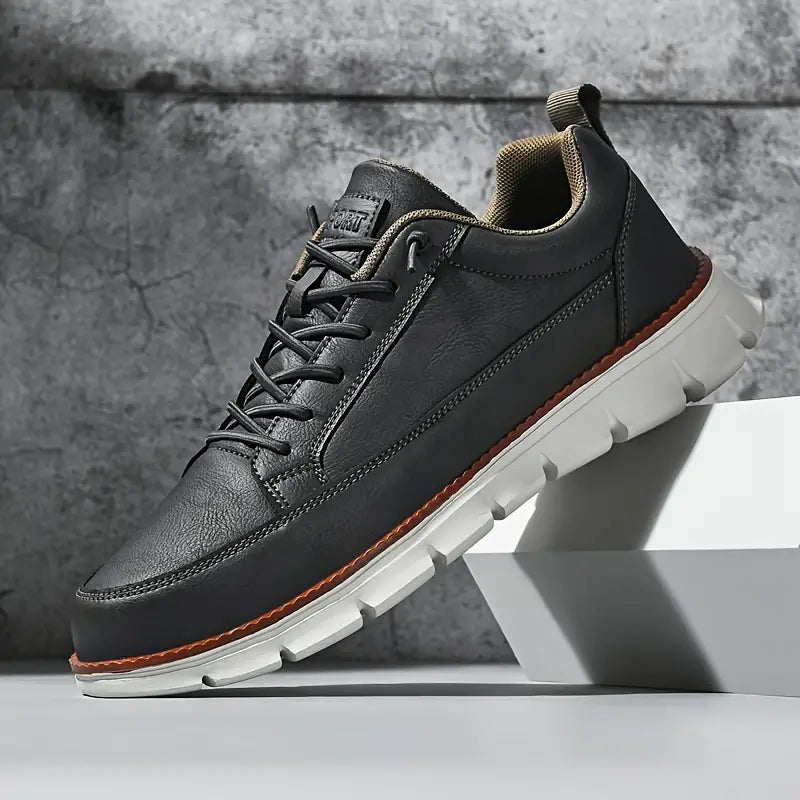 Low top lace-up sneaker with stitched panels and chunky textured sole