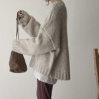 Women's ivory chunky knit sweater with crew neckline and front pockets