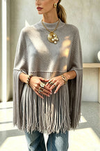 Women's knit cape sweater with crew neck and long tassel hem