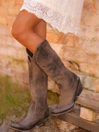Women's studded knee-high cowboy boots with pointed toes