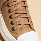 Women's platform sneakers with lace-up fronts, rounded toes and serrated soles