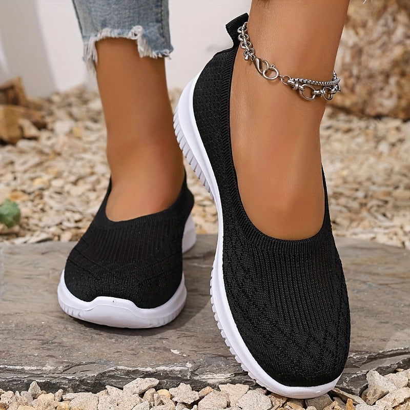 Women's knitted slip-on shoes with closed rounded toe and white ridged sole