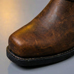 Tall men's biker boot with ankle straps, metal studs and low heel
