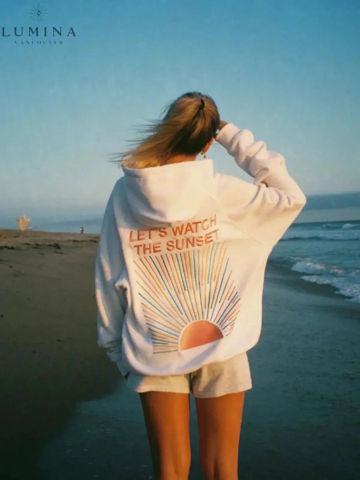 Women's hoodie with sunset graphic on the back