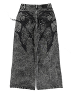 Women's black wide-leg jeans with graphic printed panels and flap pockets