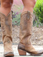 Women's studded knee-high cowboy boots with pointed toes