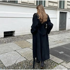 Women's black oversized long coat with lapel collar and button front