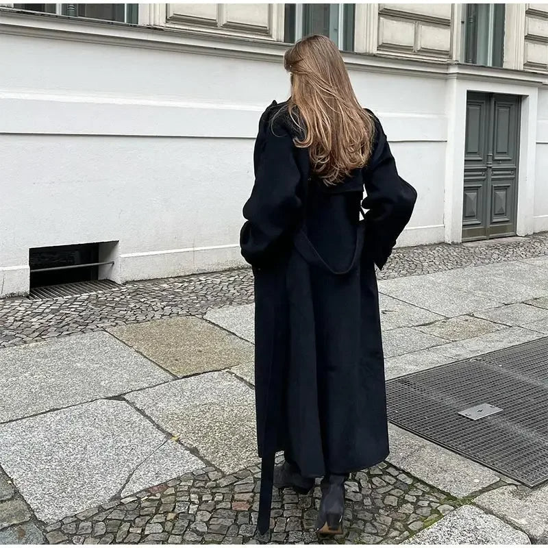 Women's black oversized long coat with lapel collar and button front