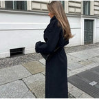Women's black oversized long coat with lapel collar and button front