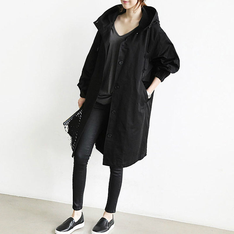 Women's hooded button-front trench coat with long sleeves and side pockets