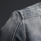 Men's blue-grey washed denim jacket with stand collar, long sleeves and zipped pockets