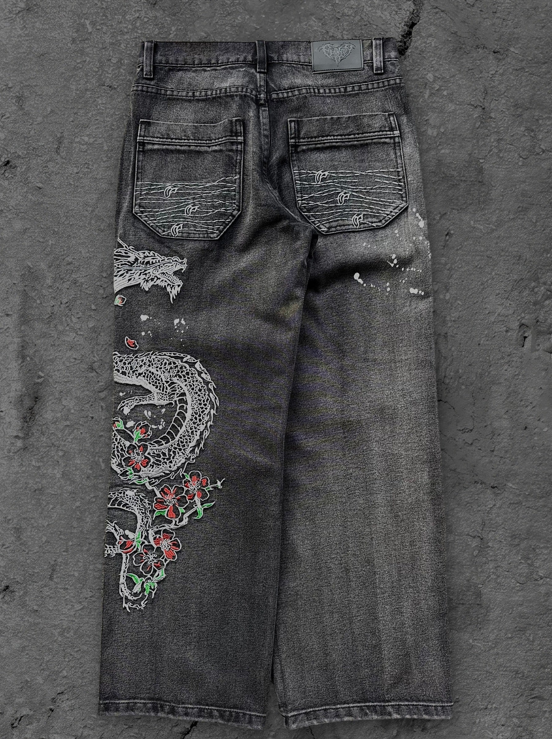 Dark washed wide leg jeans with dragon and floral embroidery