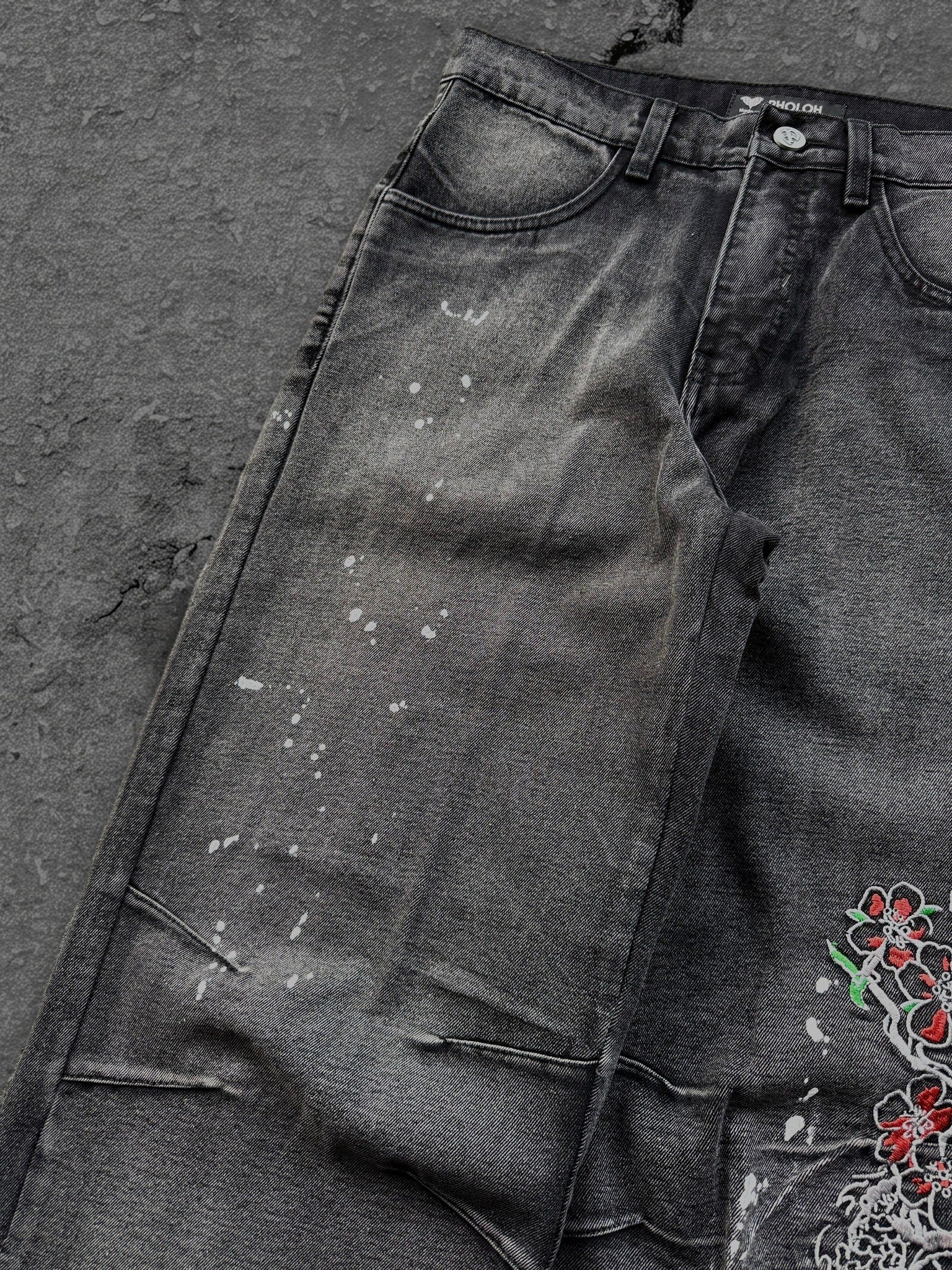 Dark washed wide leg jeans with dragon and floral embroidery