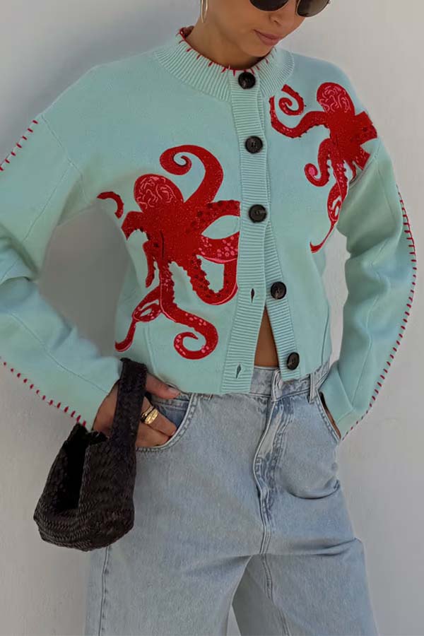 Women's pale blue cardigan with red octopus graphics and button front