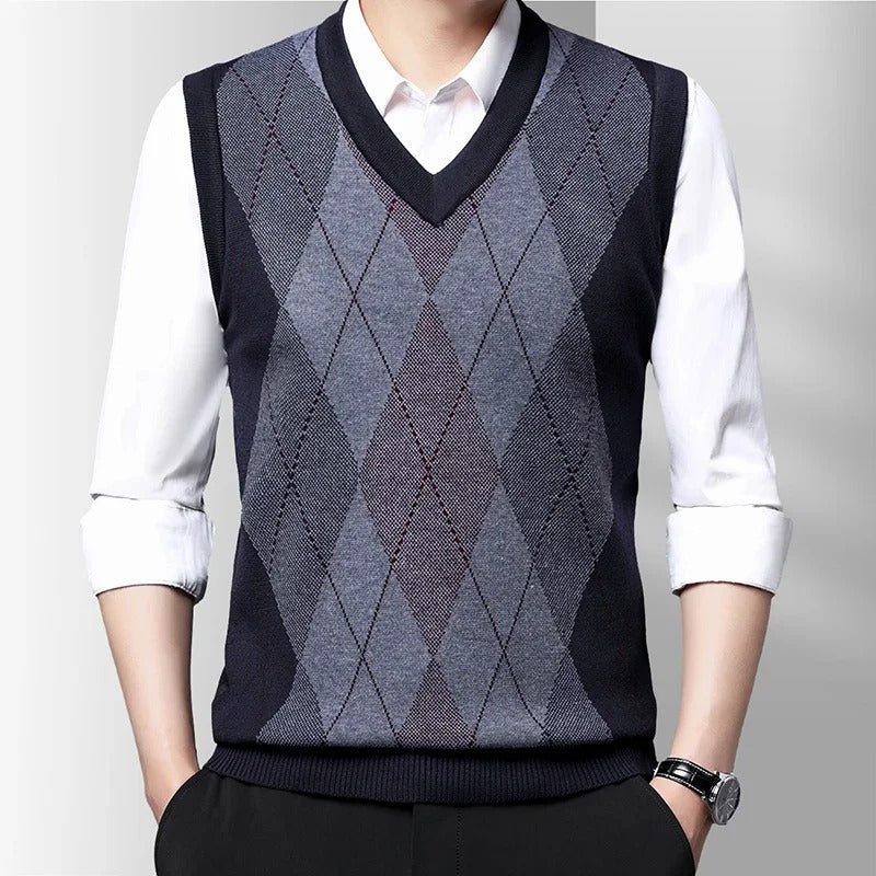 Men's sleeveless argyle V-neck sweater vest layered over a white shirt