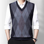 Men's sleeveless argyle V-neck sweater vest layered over a white shirt